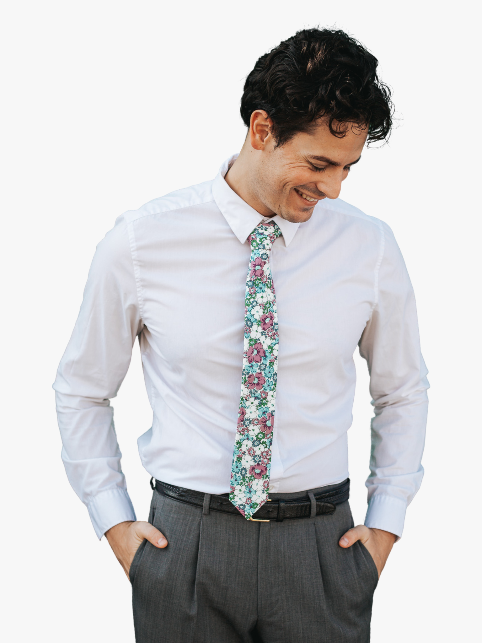 A man in dress clothes wearing a floral tie with blue flowers, lavender purple petals, and green blossoms.