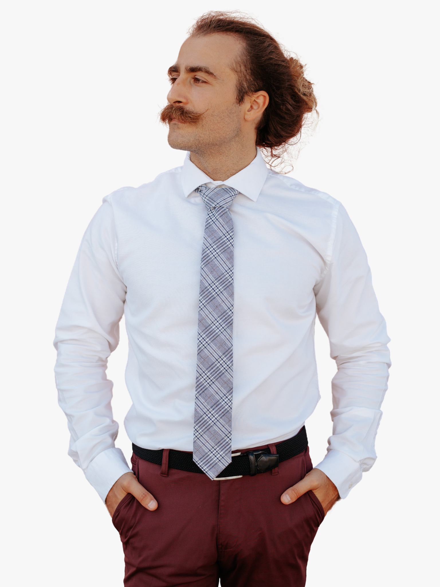 A man wearing a plaid tie with navy plaid pattern with light blue stripes, diagonal white bars and diagonal designs.