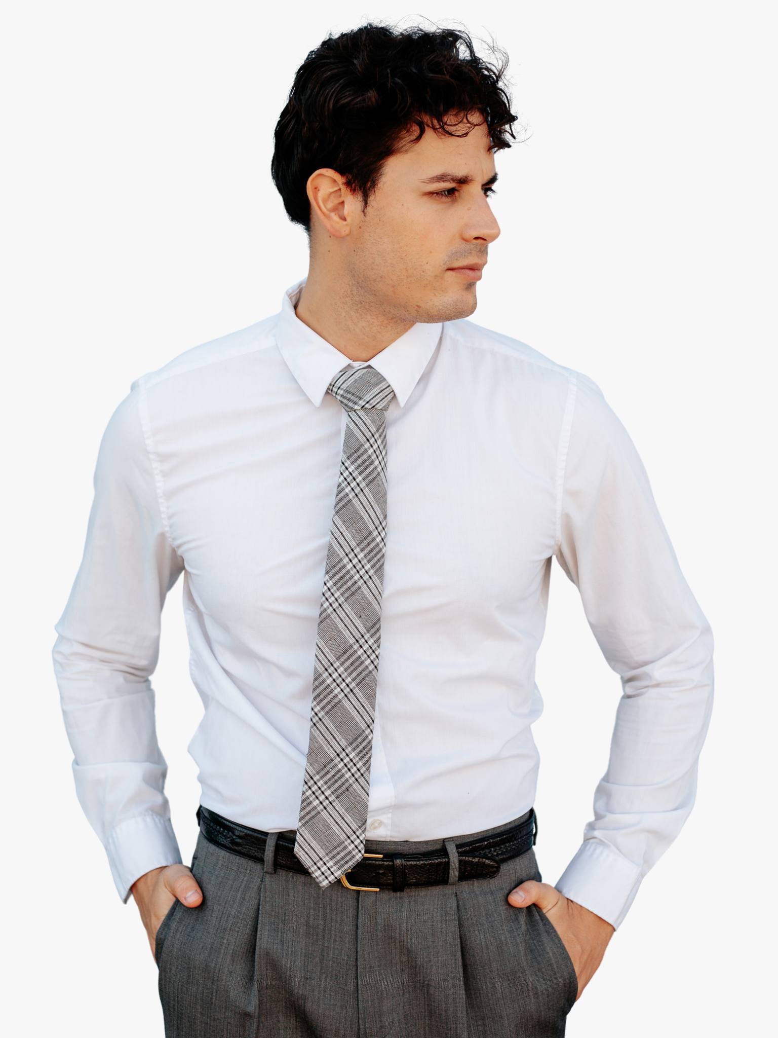 A man wearing a plaid tie with black plaid pattern with light gray stripes, diagonal white bars and diagonal designs.