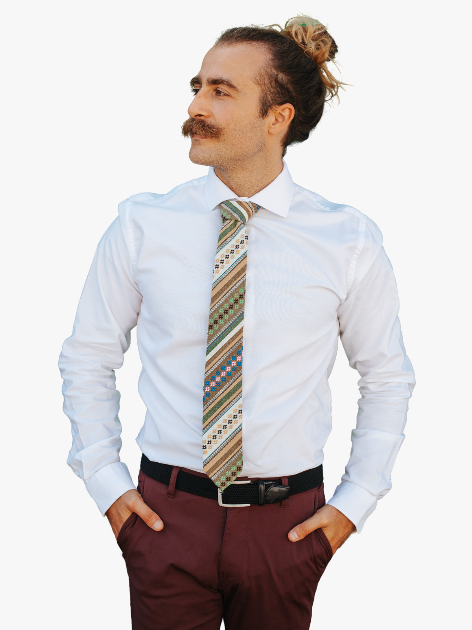 A man wearing church clothes and a striped tie with green stripe, tan lines, brown bars and cross designs.