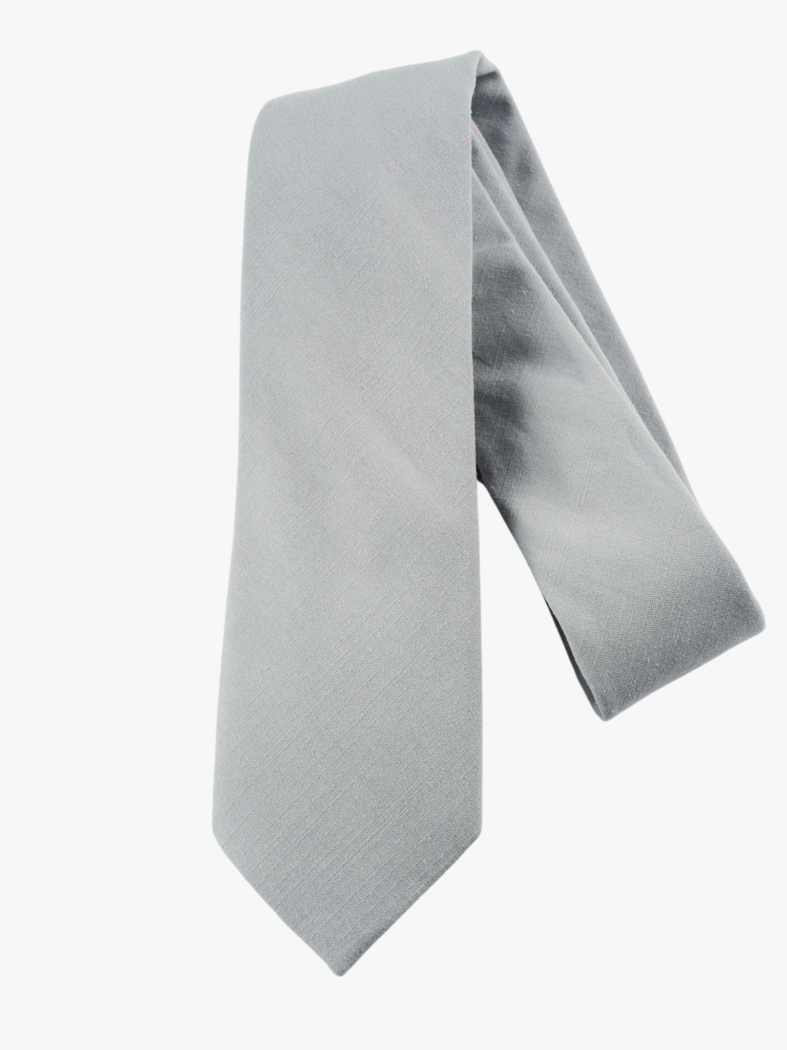 A folded solid woven cotton men's necktie with a simple pale solid blue/gray color.