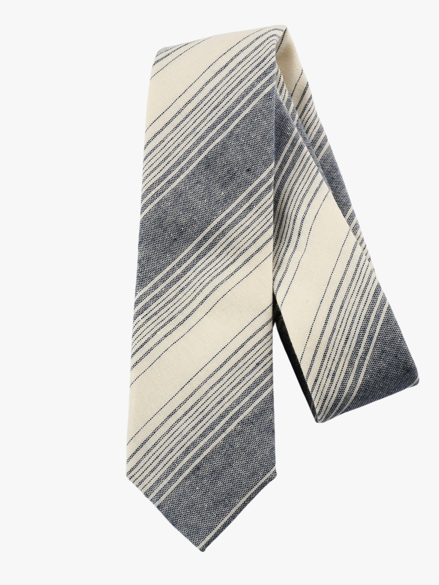 A folded pure cotton, striped adult men's necktie with navy blue stripes, thin beige cream lines,  and diagonal designs.