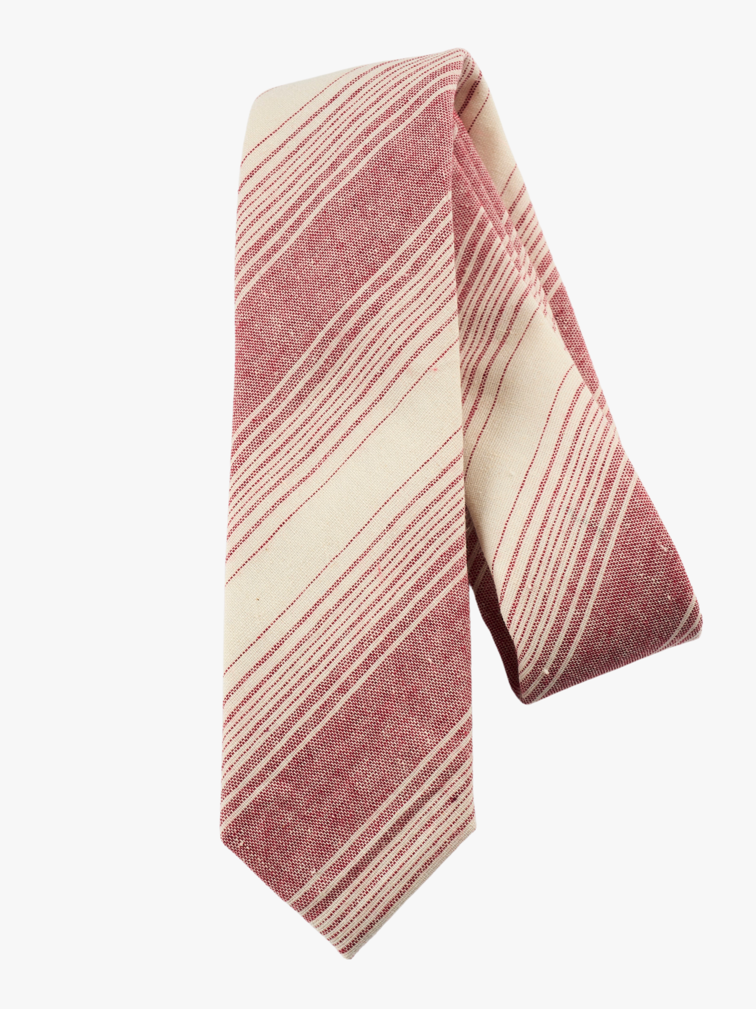 A folded striped adult men's necktie with crimson red stripes, thin beige cream lines,  and off-white diagonal designs.