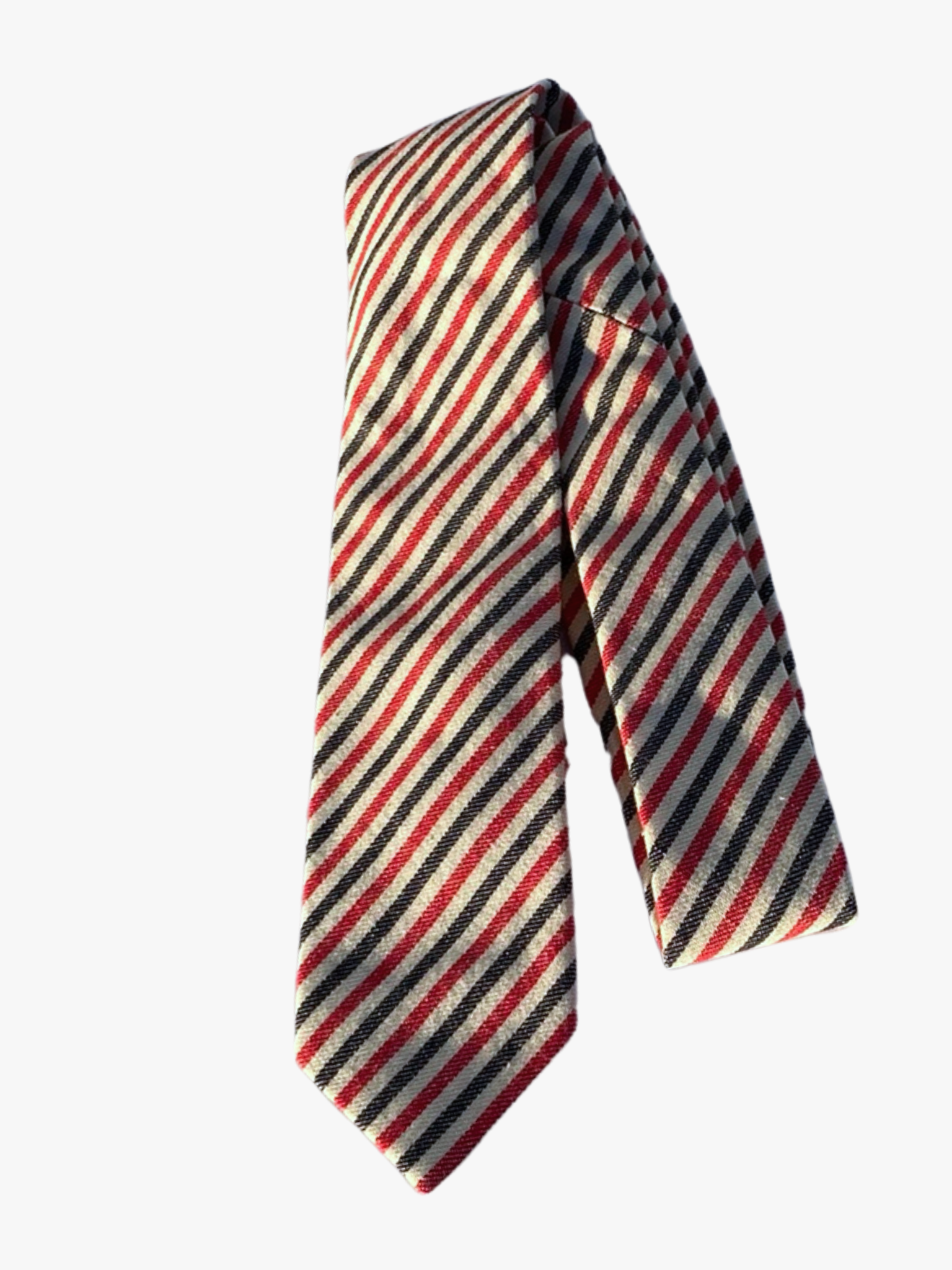 A folded striped adult men's necktie with alternating red and navy blue stripes on a creamy beige background fabric.