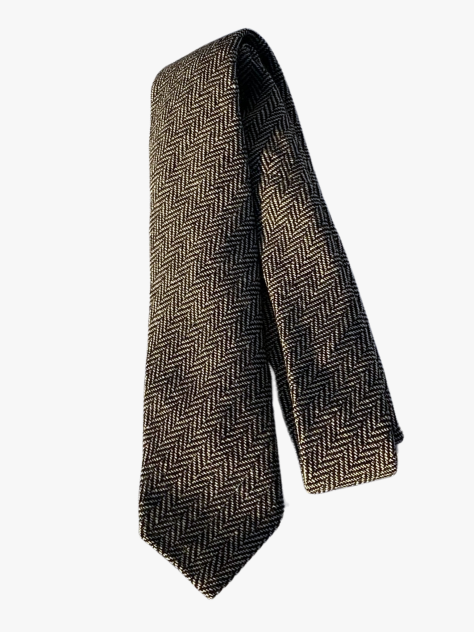 A folded herringbone adult men's necktie with alternating black and tan arrows designs on a soft cotton fabric.