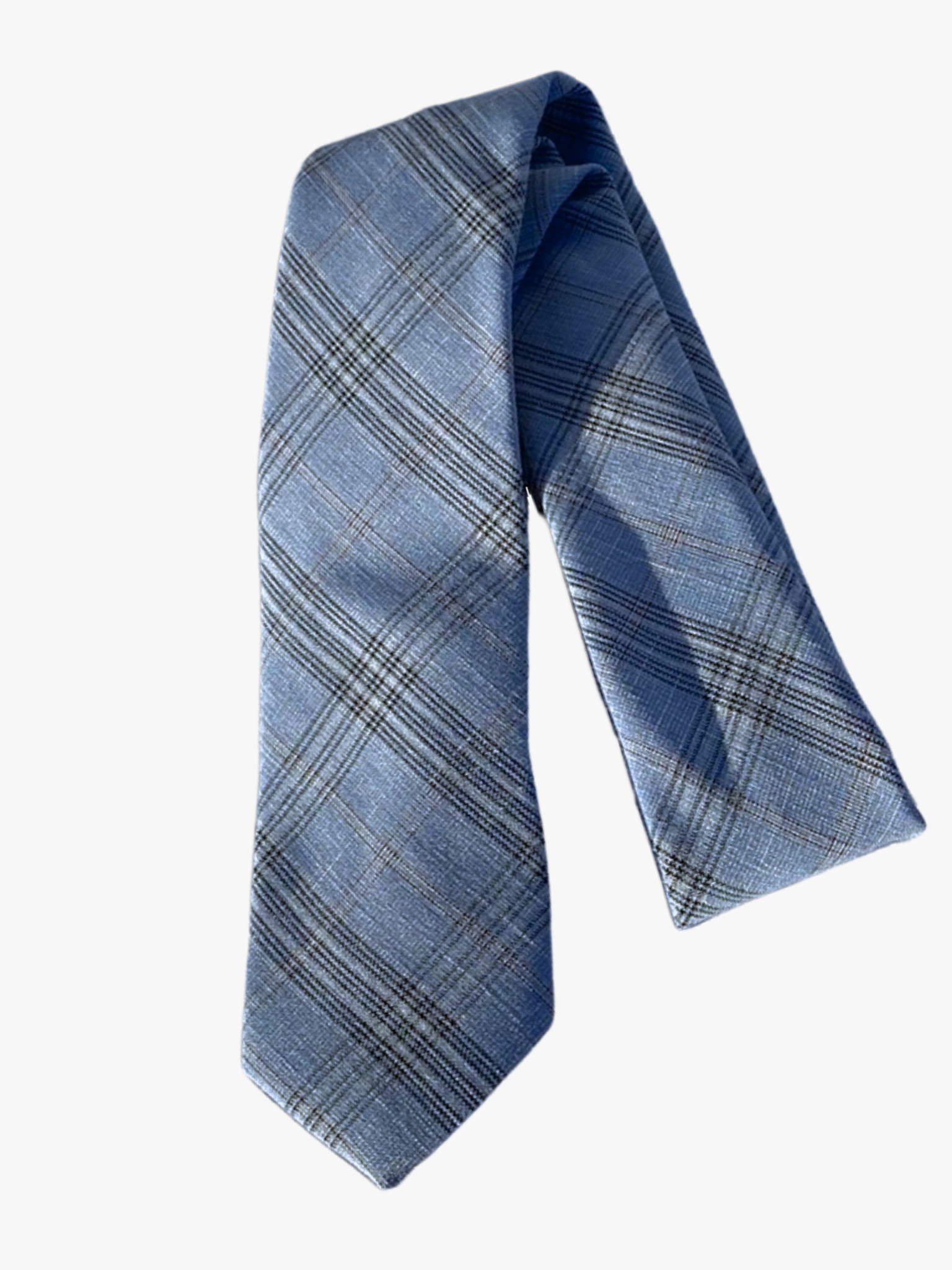 A folded tight plaid adult men's necktie with intersecting grids of dark blue and white.