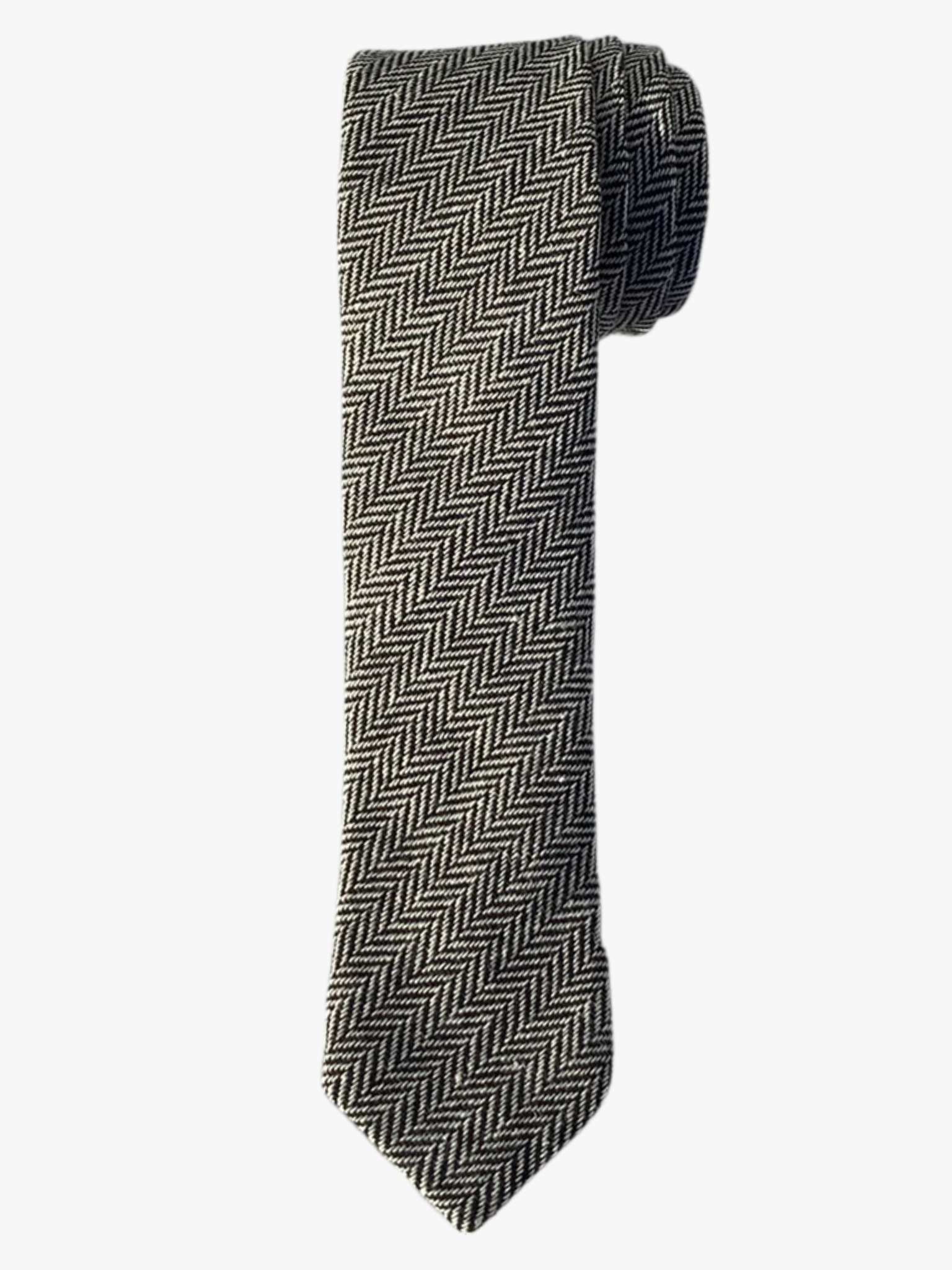 A rolled up white and black herringbone cotton necktie for teens, missionaries, men, and women.