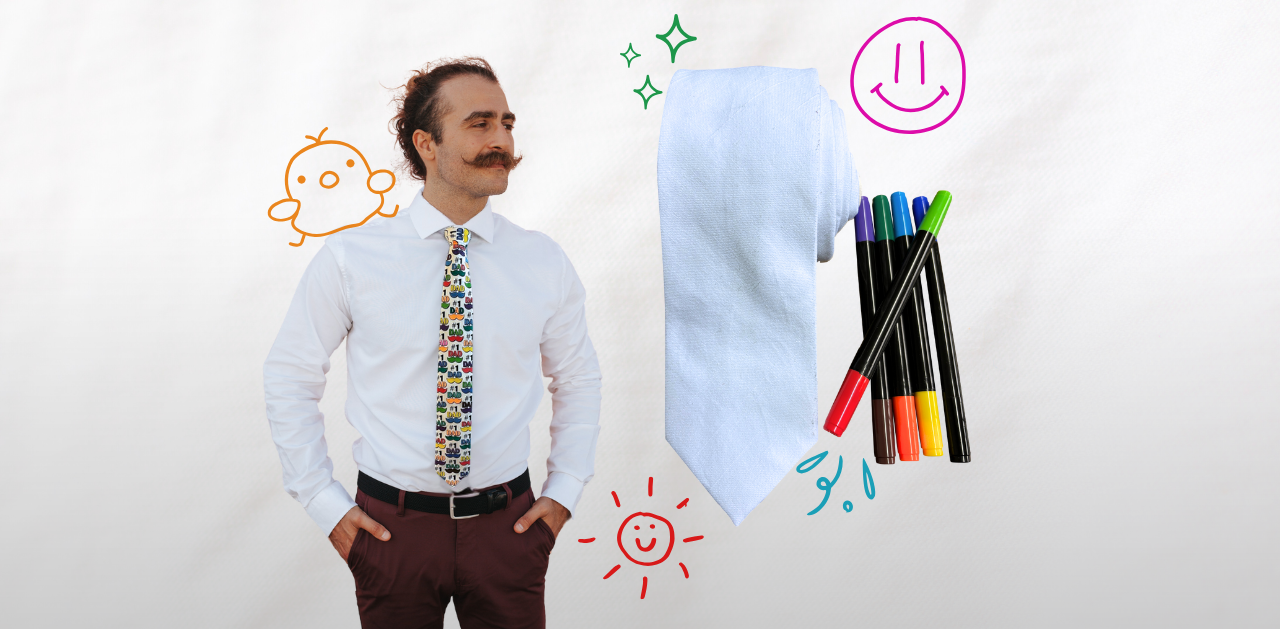 A man in a colorful Father's Day necktie with mustache icons on it. Next to him is a blank white necktie with fabric markers.