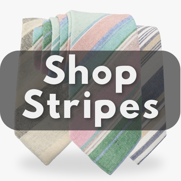 A collection of 3 diagonal striped ties for men in behind a sign promoting striped ties. 