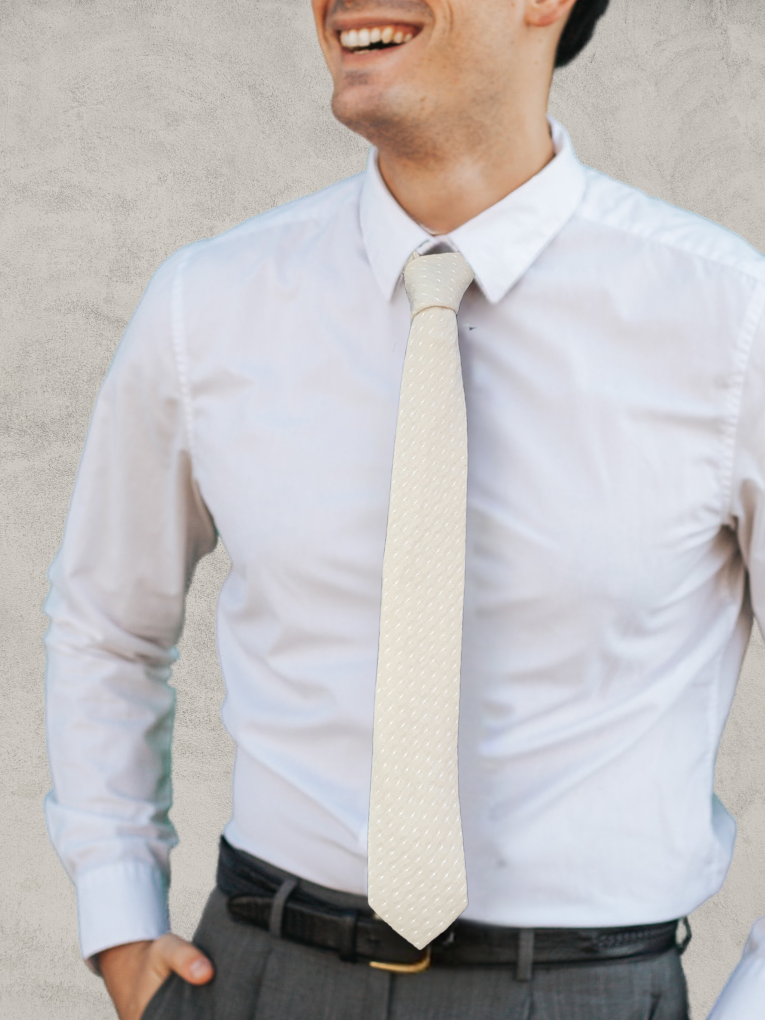 A close up of a man wearing a khaki tan and white polka dot cotton tie for weddings, grooms, and groomsmen.
