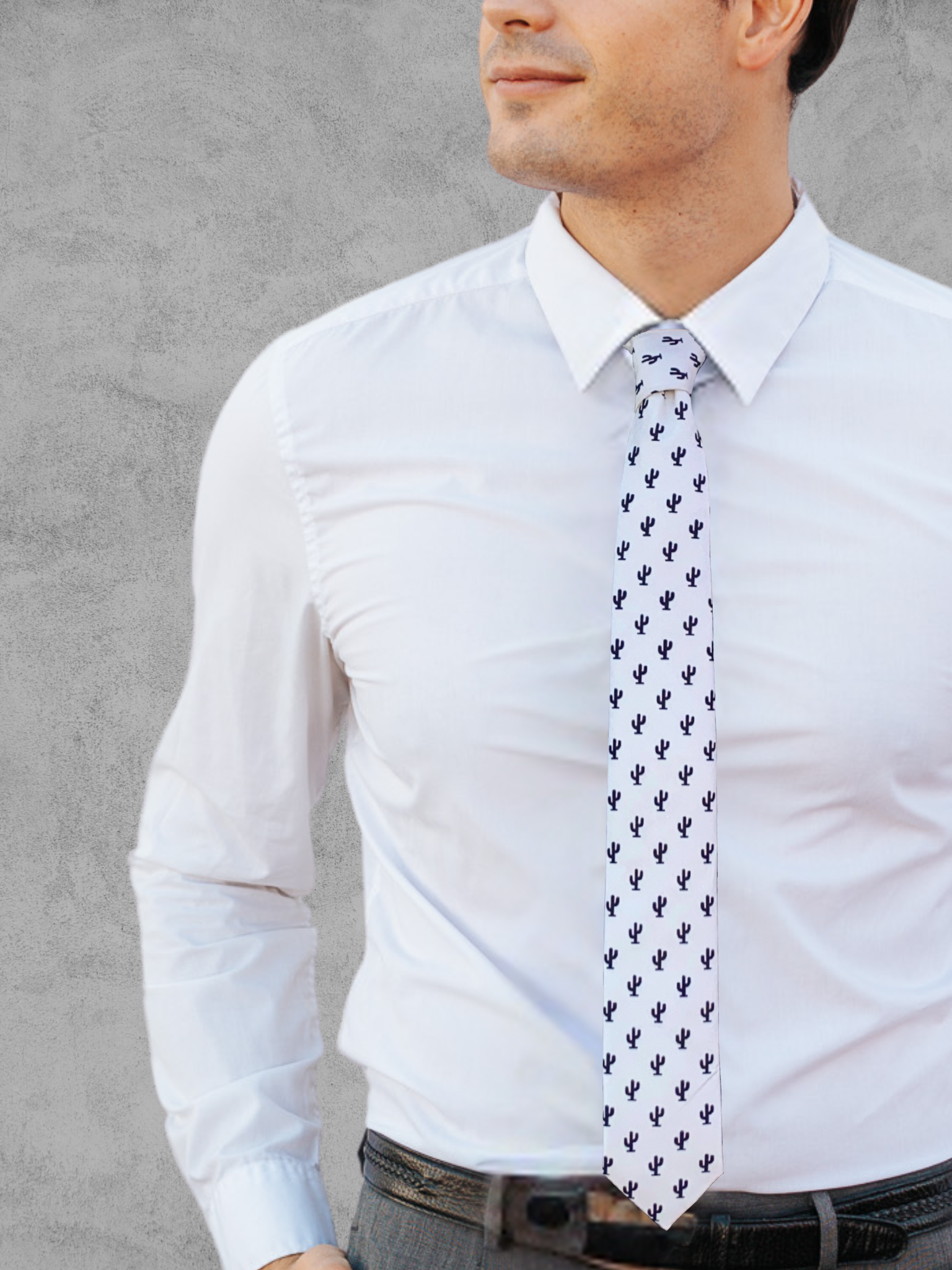 A close up of a man wearing a black and white Arizona desert cactus cotton tie for parties, church, and work.