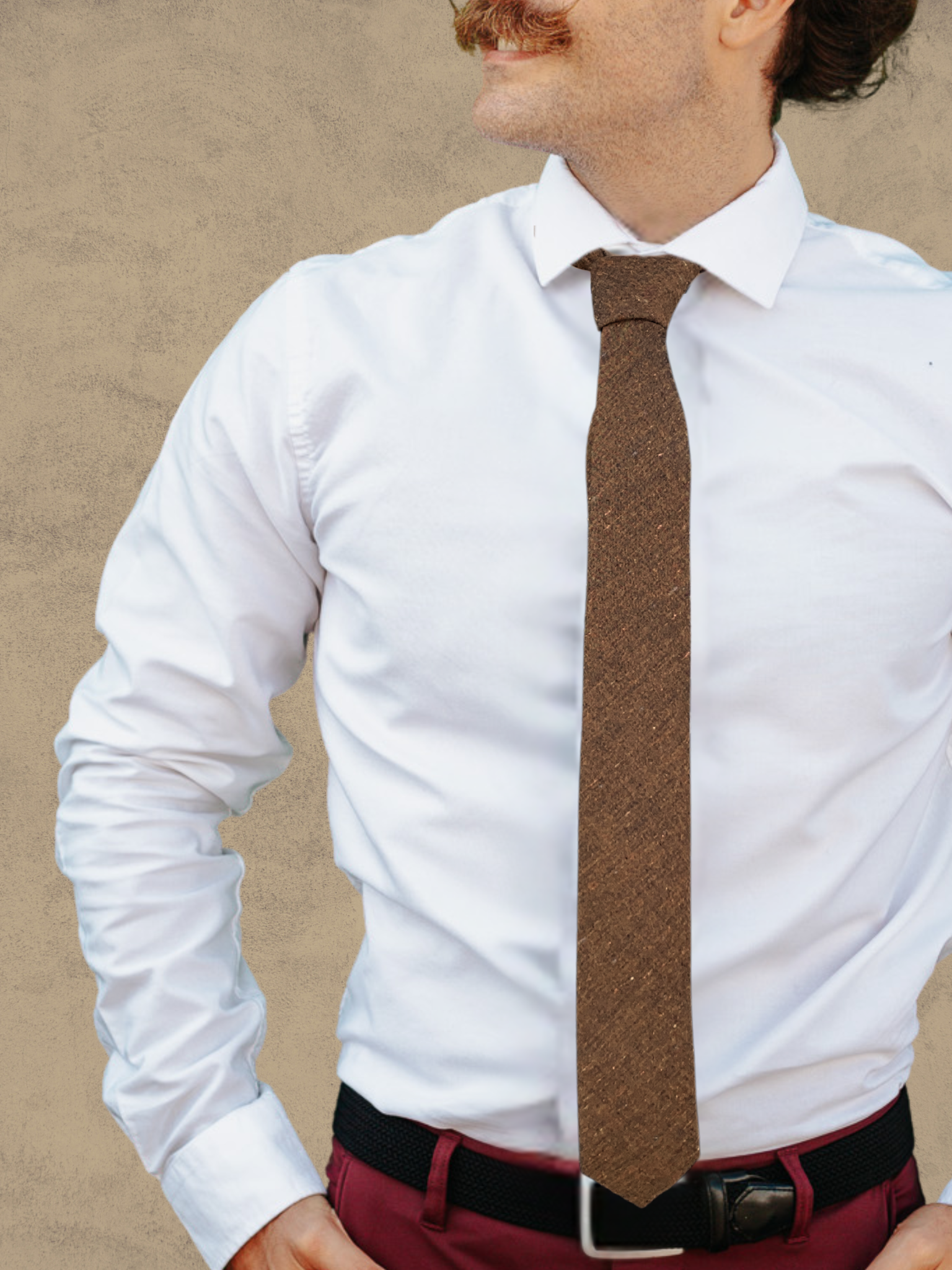 A close up of a man wearing a copper and brown solid speckled cotton tie for weddings, grooms, and groomsmen.