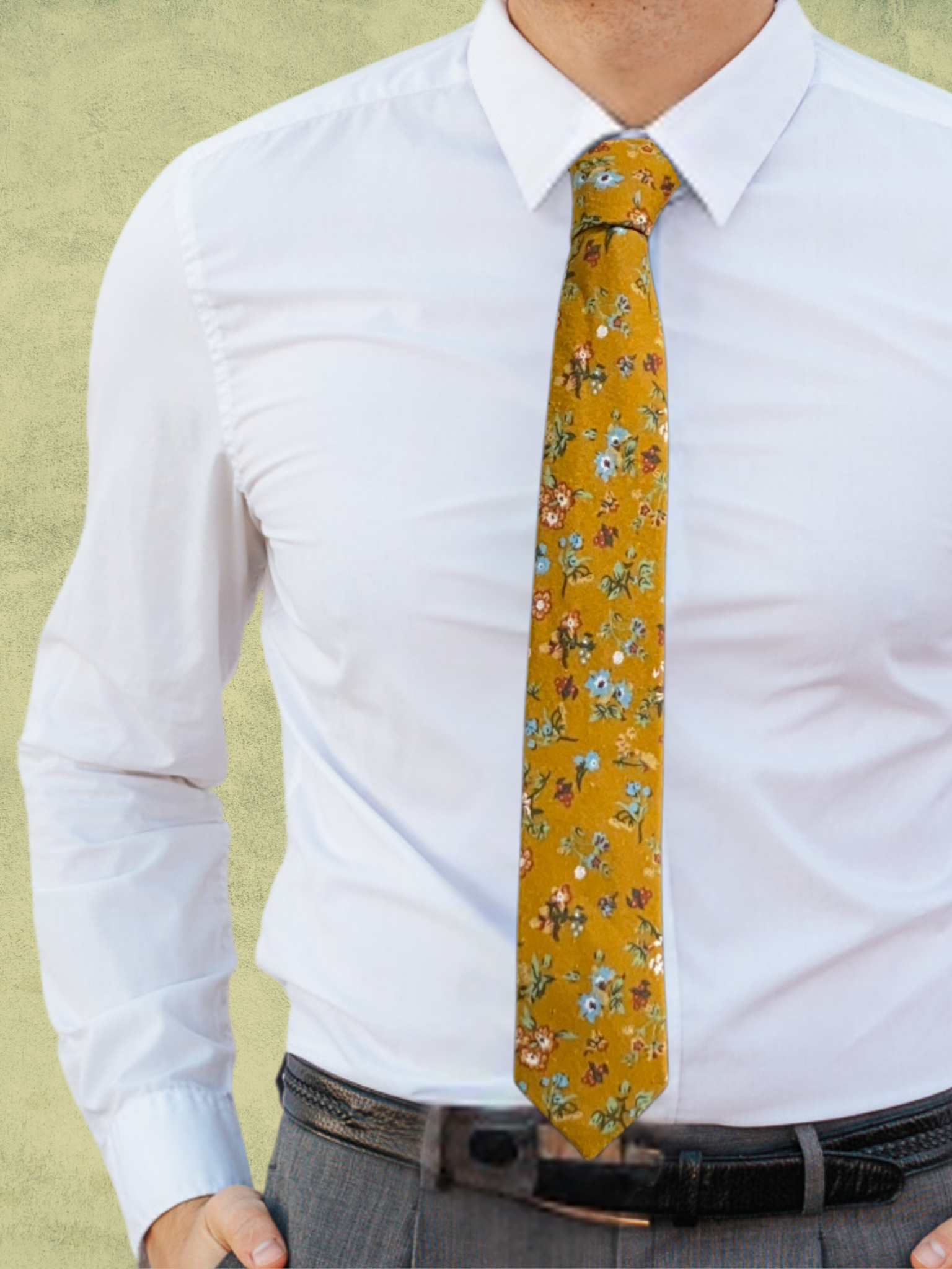 A close up of a man wearing a yellow, pale blue, green, red, and white flower cotton tie for weddings grooms and groomsmen.