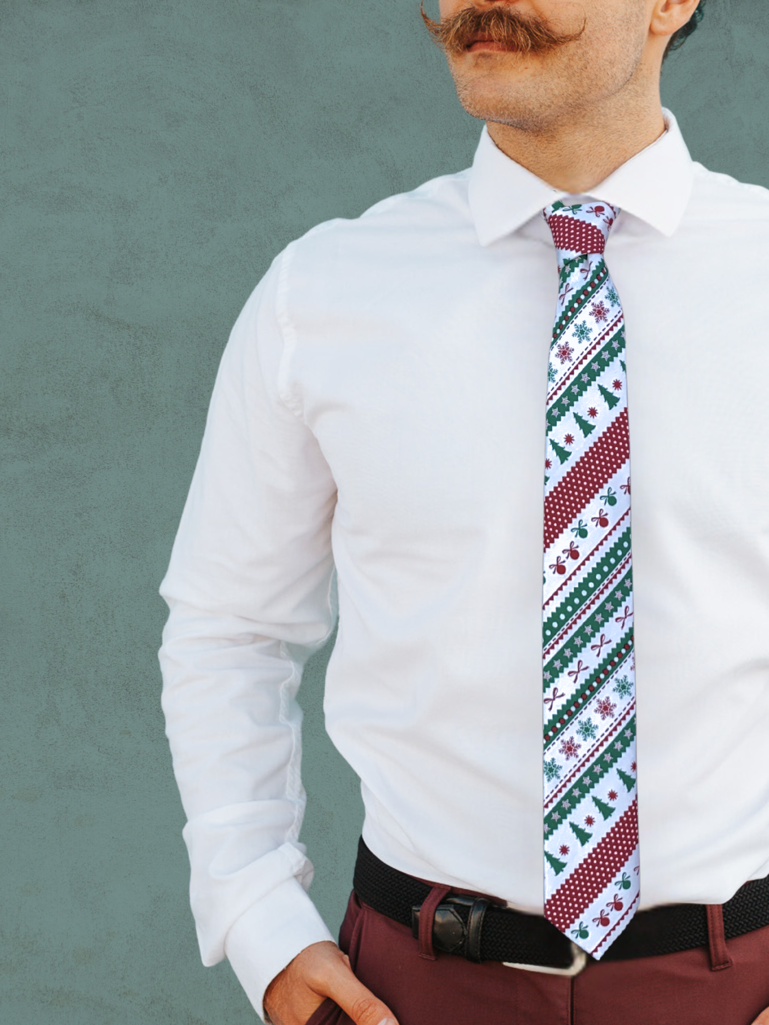 A close up of a man wearing a green and red ugly Christmas sweater cotton tie for parties, church, and work.