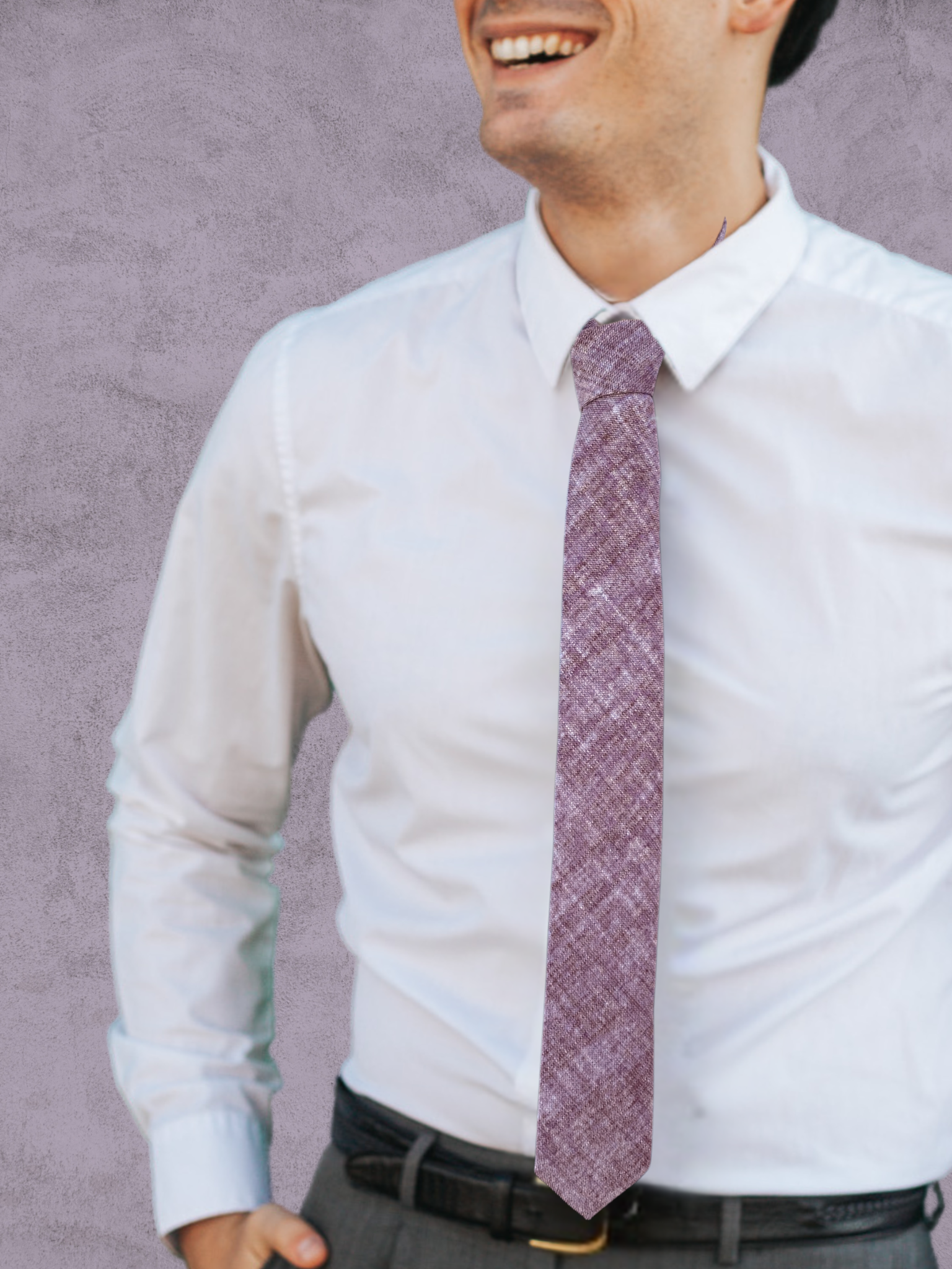 A close up of a man wearing a light salt pink and dark pink solid speckled cotton tie for weddings, grooms, and groomsmen.