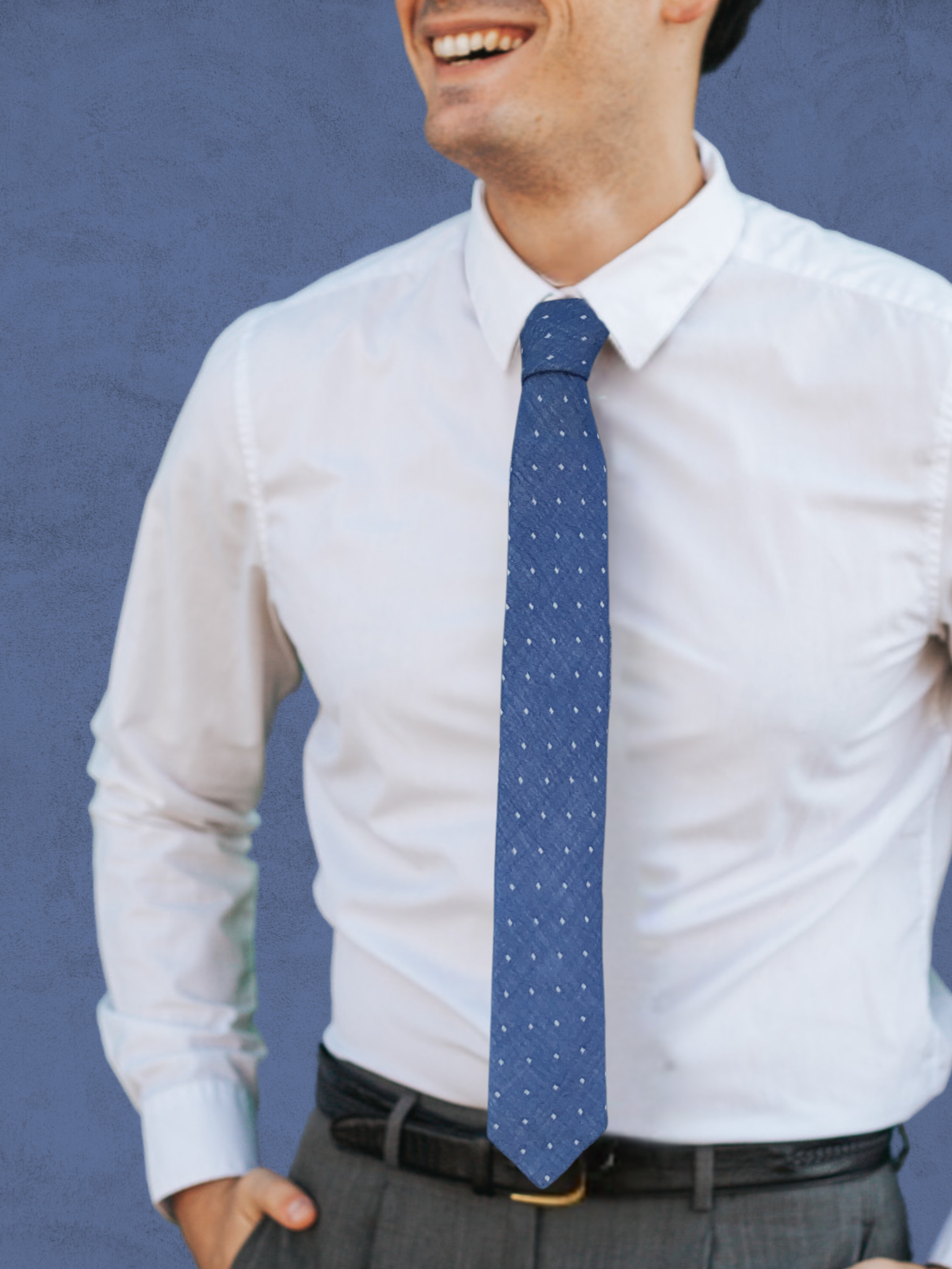 A close up of a man wearing a navy blue and white polka dot cotton tie for weddings, grooms, and groomsmen.