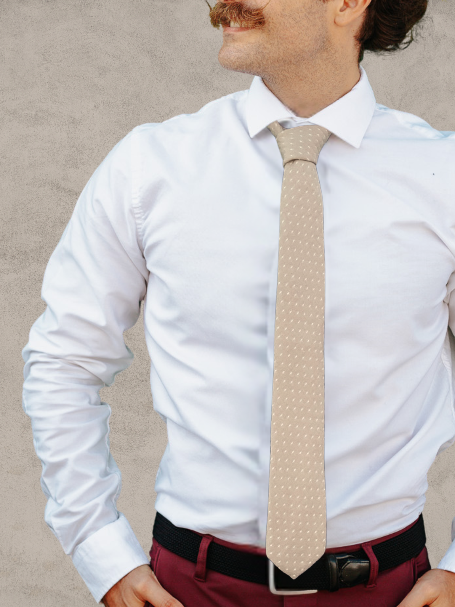 A close up of a man wearing a sandy tan and white polka dot cotton tie for weddings, grooms, and groomsmen.