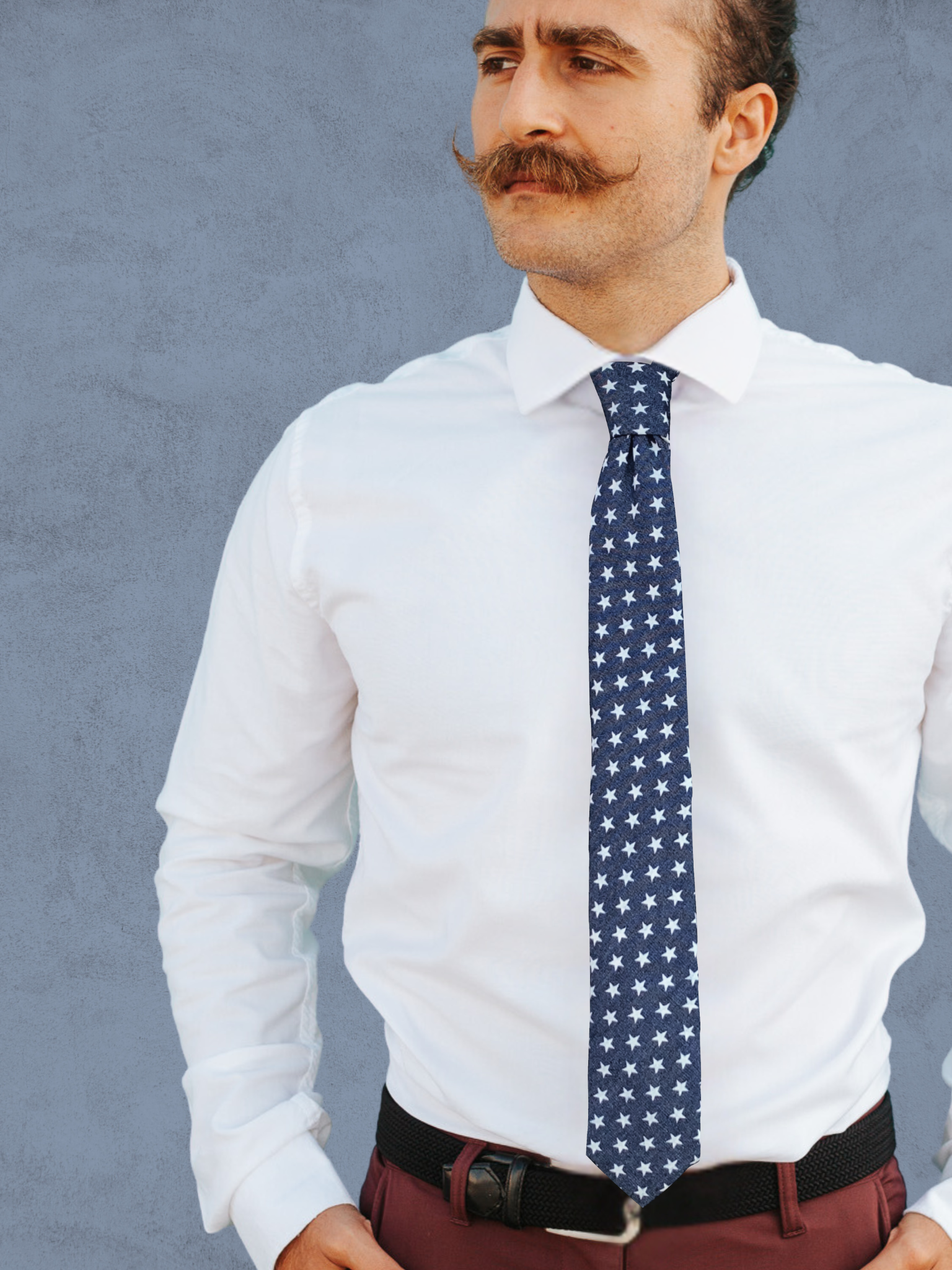 A close up of a man wearing a white and navy blue USA stars cotton tie for parties, church, and work.