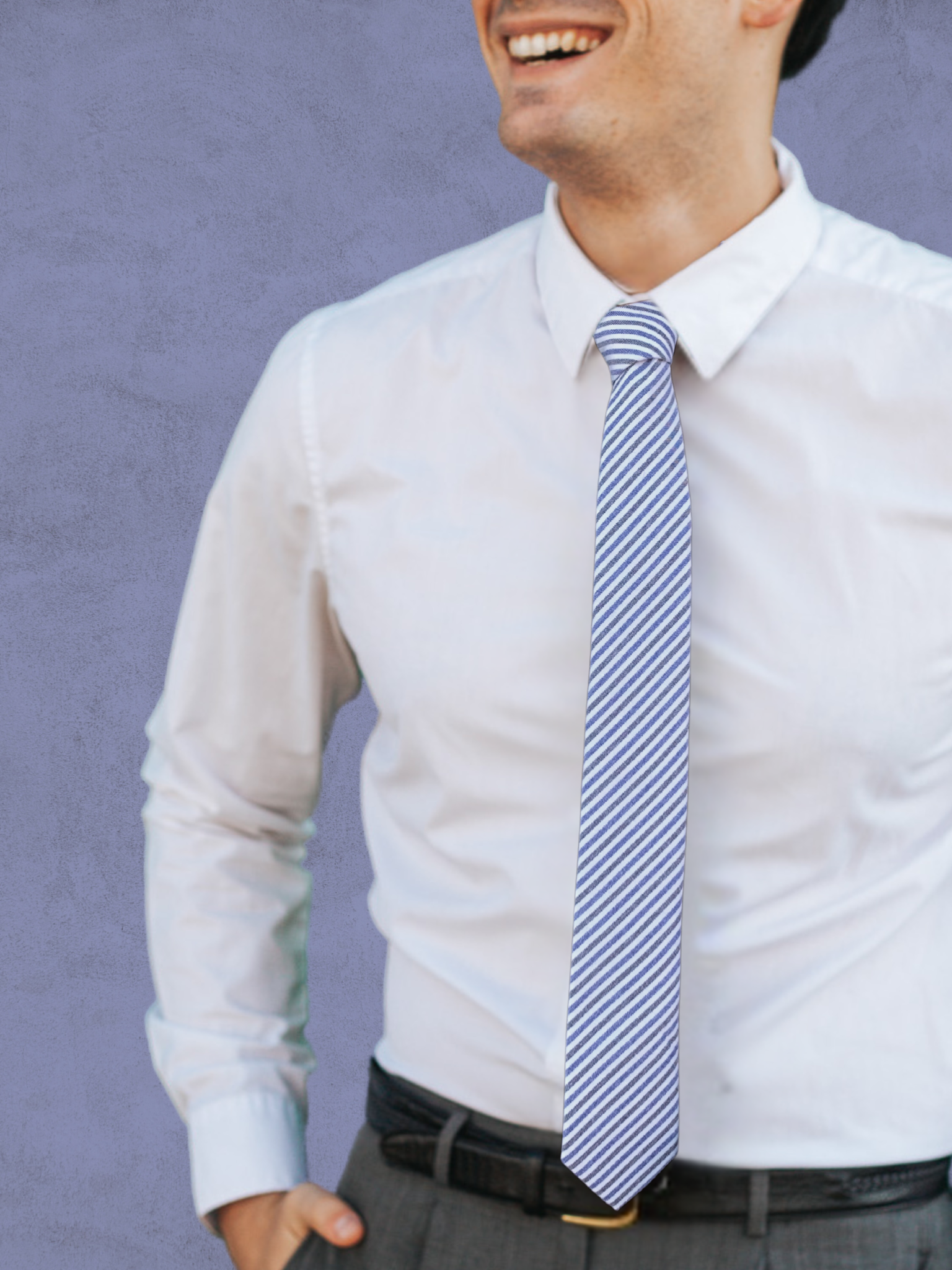 A close up of a man wearing a white, blue, and gray striped cotton tie for weddings, grooms, and groomsmen.